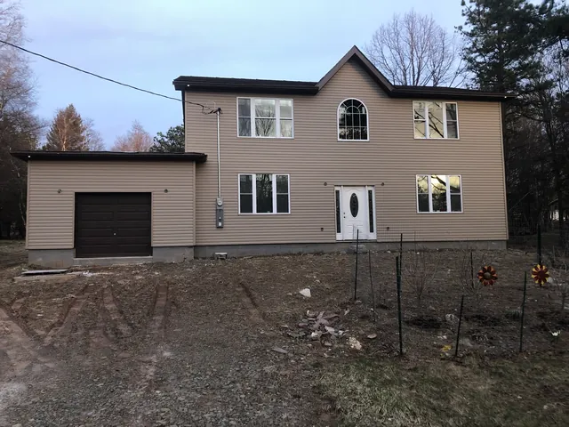 Finished two-story house with siding and garage