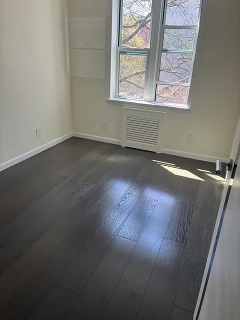 After: finished room with dark hardwood floors