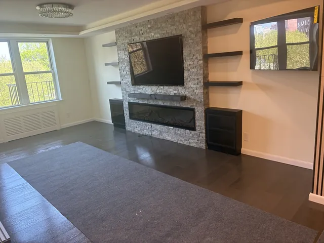 Living room with stone fireplace wall