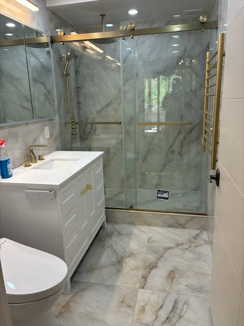 Glass shower with brushed-gold fixtures